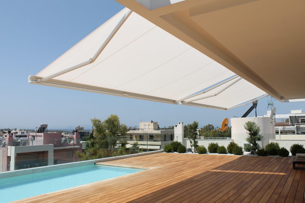 Premium markilux MX-3 awning providing shade for a Mediterranean outdoor living space